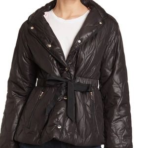 Quilted  with ribbon drawstring. Zippered  at collar with hood. Silver hardware